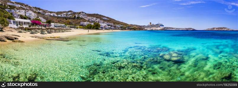 Scenic beaches of Mykonos island. Beautiful Agios Stefanos near New port. View with big cruise ship liner. Greece, Cyclades travel