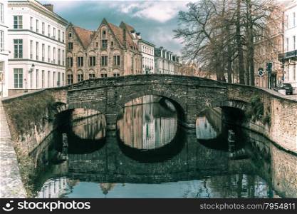 Scenic city view of Bruges canal and bridge, Belgium. Toning in cool tones