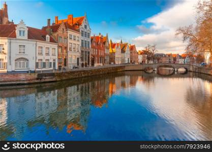 Scenic city view of Bruges canal Spiegelrei with beautiful medieval houses, their reflections and Bridge Carmersbrug, Belgium