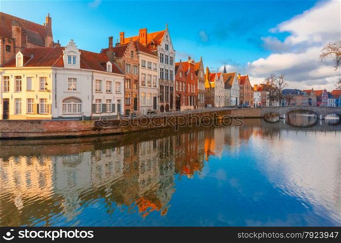 Scenic city view of Bruges canal Spiegelrei with beautiful medieval houses, their reflections and Bridge Carmersbrug, Belgium