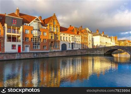 Scenic city view of Bruges canal Spiegelrei with beautiful medieval houses, their reflections and Bridge Koningsbrug, Belgium