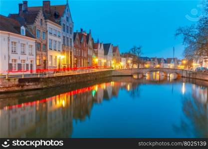 Scenic city view of Bruges canal with beautiful medieval colored houses, bridge and reflections, Belgium