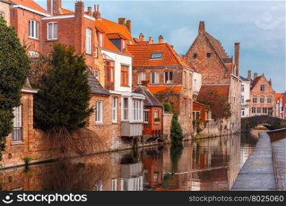 Scenic city view of Bruges canal with beautiful medieval houses and their reflection, Belgium