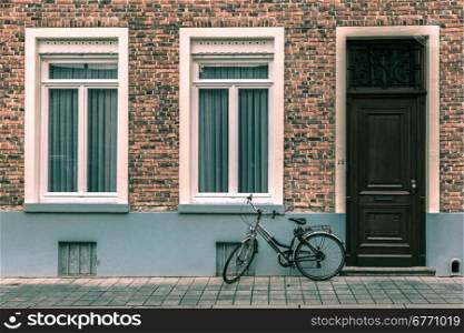 Scenic city view of Bruges street with bike, Belgium. Toning in cool tones