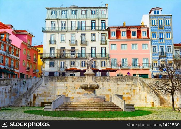 Scenic cityscape of Lisbon Old Town with traditional colorful tiled architecture, old fountain at small paved square, Portugal