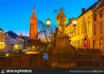 Scenic cityscape with a medieval fairytale canal, Bridge St. Nepomuk and the quay Dijver and Church of Our Lady at sunset in Bruges, Belgium