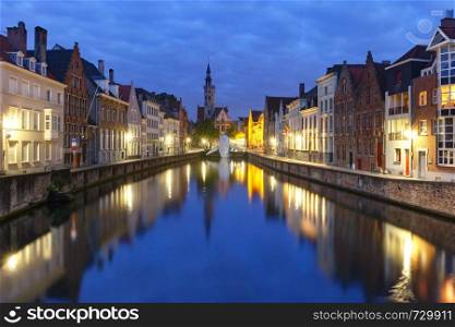 Scenic cityscape with a medieval fairytale Old town and Spiegelrei canal at night in Bruges, Belgium. Old town at night, Bruges, Belgium