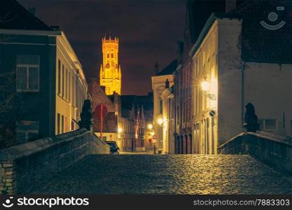Scenic cityscape with a medieval fairytale town and tower Belfort at night in Bruges, Belgium