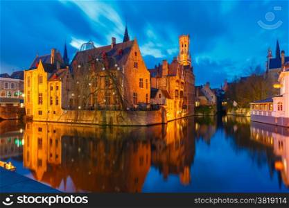 Scenic cityscape with a medieval fairytale town and tower Belfort from the quay Rosary (Rozenhoedkaai) at sunset in Bruges, Belgium