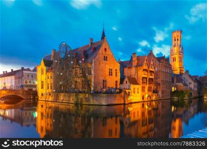 Scenic cityscape with a medieval fairytale town and tower Belfort from the quay Rosary, Rozenhoedkaai, at sunset in Bruges, Belgium