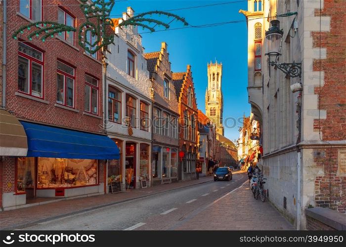 Scenic cityscape with a medieval street and tower Belfort in the christmas morning in Bruges, Belgium