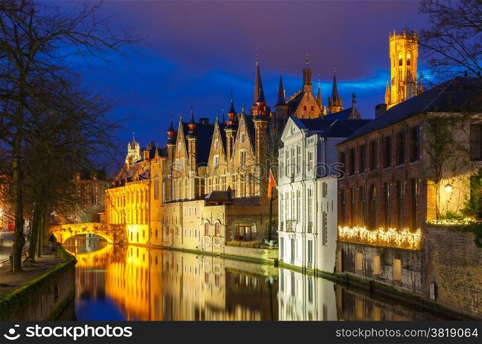 Scenic cityscape with a medieval tower Belfort and the Green canal (Groenerei) at sunset in Bruges, Belgium