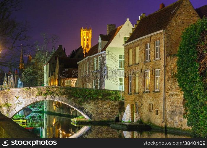 Scenic cityscape with a medieval tower Belfort and the Green canal, Groenerei, at sunset in Bruges, Belgium