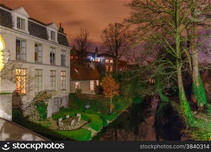 Scenic cityscape with the picturesque night medieval canal in Bruges, Belgium