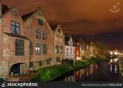 Scenic cityscape with the picturesque night medieval canal in Bruges, Belgium