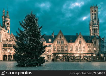 Scenic cityscape with the picturesque night medieval Christmas Burg Square in Bruges, Belgium. Toning in cool tones