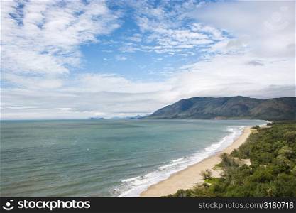 Scenic coastal view from Queensland Rex Lookout with mountains in background under blue sky with clouds.