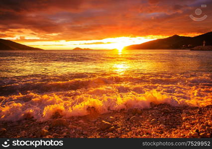 Scenic colorful sunset at the sea coast. Good for wallpaper or background image.