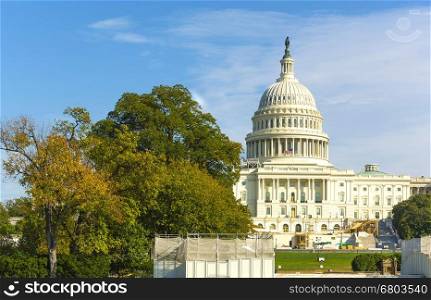 Scenic detail view of the Capitol Building in Washington, DC, USA with leafy green summer trees in the foreground