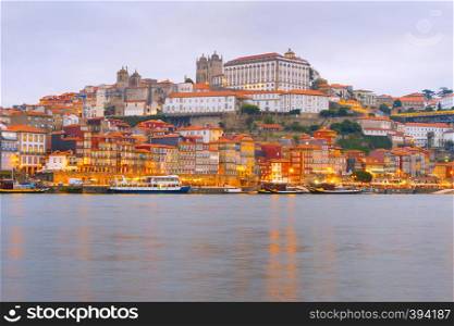 Scenic evening Porto cityscape with Douro embankment and illuminated old town architecture, Portugal
