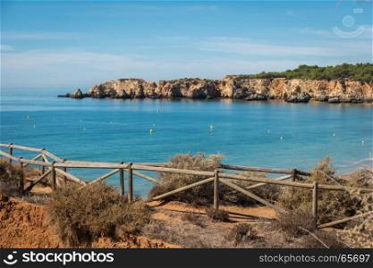 Scenic golden cliffs near Alvor, Portimao. This beach is a part of famous tourist region Algarve
