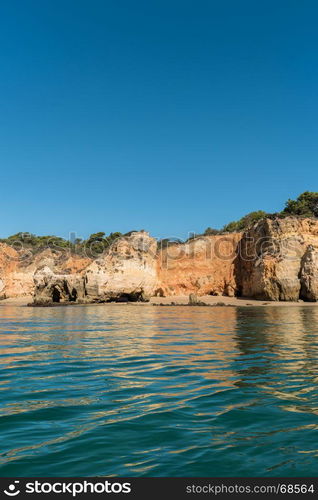 Scenic golden cliffs near Alvor, Portimao. This beach is a part of famous tourist region Algarve