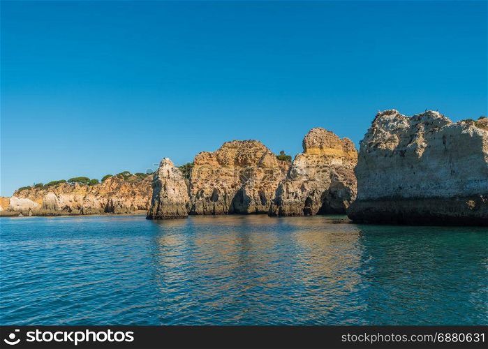 Scenic golden cliffs near Alvor, Portimao. This beach is a part of famous tourist region Algarve