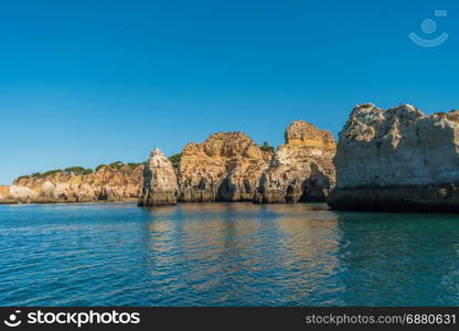 Scenic golden cliffs near Alvor, Portimao. This beach is a part of famous tourist region Algarve