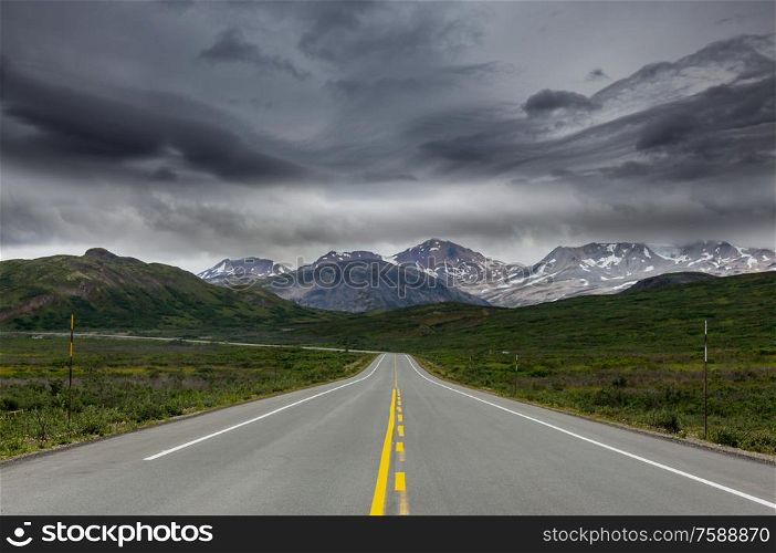 Scenic highway in Alaska, USA. Dramatic view storm clouds