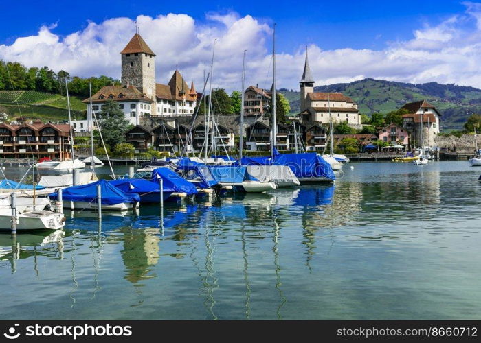 Scenic lake Thun and the Spiez village with its famous medieval castle and old town in the alps in Canton Bern in Switzerland