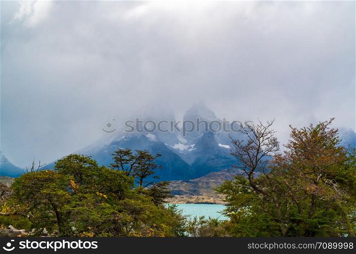 Scenic landscape in Torres del Paine national park in Chile with the foggy mountain