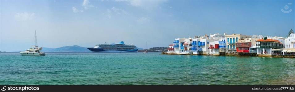 Scenic Little Venice houses in Chora Mykonos town with yacht and cruise ship. Mykonos island, Greecer. Little Venice houses in Chora Mykonos town with yacht and cruise ship. Mykonos island, Greecer