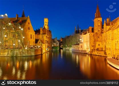 Scenic night cityscape with a medieval fairytale town and tower Belfort from the quay Rosary (Rozenhoedkaai) in Bruges, Belgium