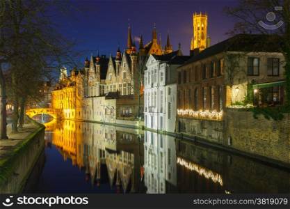 Scenic night cityscape with a medieval tower Belfort and the Green canal (Groenerei) in Bruges, Belgium