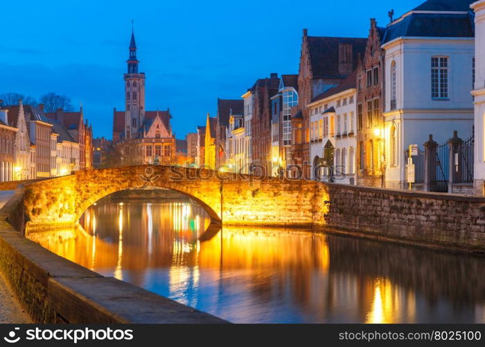 Scenic night cityscape with views of Spiegelrei, Canal Spiegel, bridge and church in Bruges, Belgium