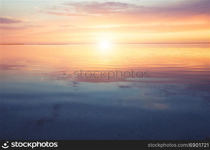 Scenic ocean sunset over the calm water surface