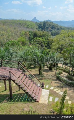 Scenic of mountain with resort garden in sunny day