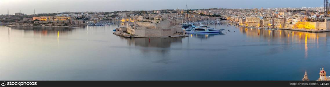 Scenic panoramic view of the city and bay at sunrise. Malta. Valletta.. Malta. Panoramic view of the city and the bay in the early morning.