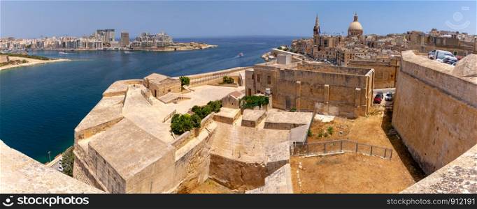 Scenic panoramic view of the city and bay at sunrise. Malta. Valletta.. Malta. Panoramic view of the city and the bay in the early morning.
