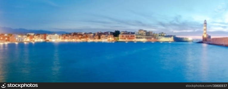 Scenic panoramic view of the old harbor with the lighthouse in Chania during twilight. Crete, Greece.