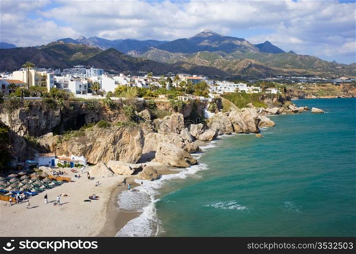 Scenic resort town of Nerja with small sandy beach on Costa del Sol by the Mediterranean Sea in Spain, southern Andalusia region, Malaga province.