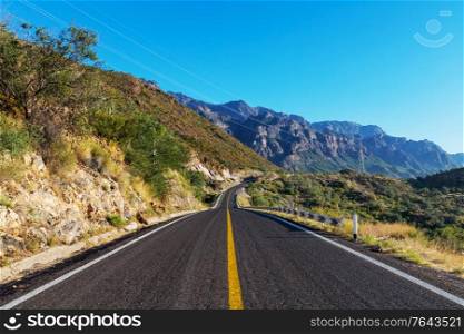 Scenic road in the mountains. Travel background.