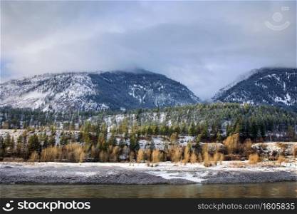 Scenic snow covered forests and mountains along Fraser River in Fraser Canyon 