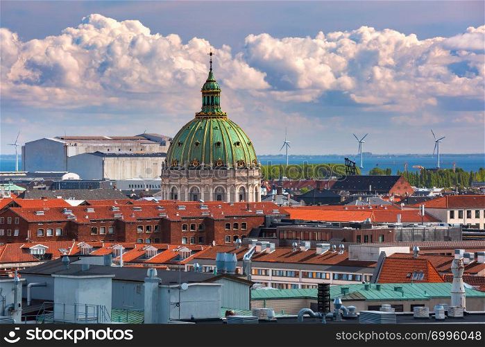 Scenic summer aerial view of Old Town skyline with Frederik&rsquo;s Church or Marble Church and lot of red roofs as seen from The Round Tower, Copenhagen, capital of Denmark. Aerial view of Copenhagen, Denmark