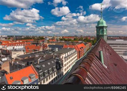 Scenic summer aerial view of Old Town skyline with Trinitatis Church and lot of red roofs as seen from The Round Tower, Copenhagen, capital of Denmark. Aerial view of Copenhagen, Denmark