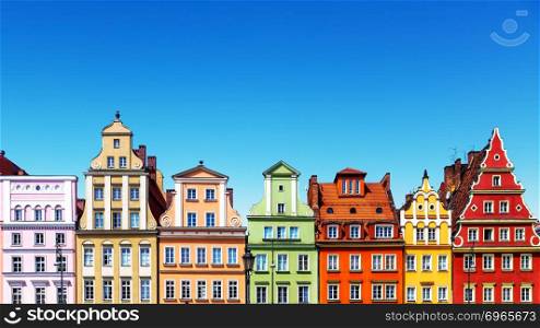 Scenic summer background view of the ancient classic color homes or houses architecture buildings with blue sky in the Old Town of Wroclaw, Poland