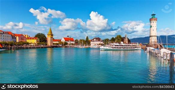 Scenic summer panorama view of the Old Town pier architecture and ancient lighthouse tower in Lindau, Bodensee or Constance Lake, Germany