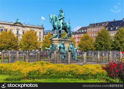 Scenic summer view of Christian V statue in Kongens Nytorv (King&rsquo;s New Square) in Copenhagen, Denmark