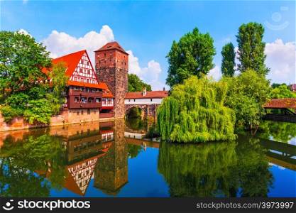 Scenic summer view of the German traditional medieval half-timbered Old Town architecture and bridge over Pegnitz river in Nuremberg, Germany