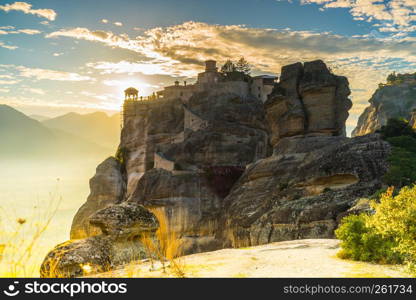 Scenic sunset evening sky over holy Varlaam monastery on cliff in Meteora, Thessaly Greece. Greek destinations. Sunset over Varlaam monastery in Meteora, Greece